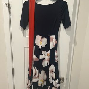 Never worn solid blue upper and flowing floral pattern bottom sleeve dress.